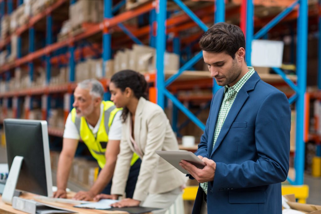 warehouse managers and worker working together