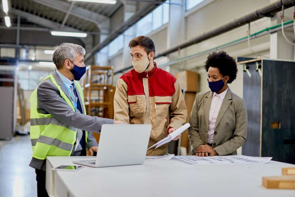woodworking company managers communicating with male worker at p